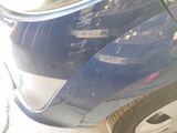 a close up of a car ' s front bumper with a sticker on it