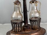a silver plate with two glass vases on top of it
