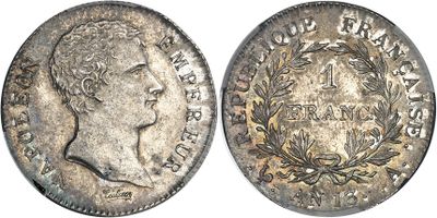 a silver coin with a crown on the front and a crown on the back