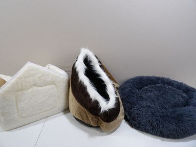 three pairs of slippers and a dog bed on the floor