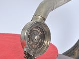 an old fashioned turntable with a red cloth on it