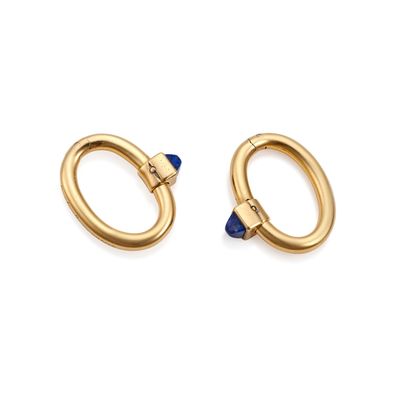 a pair of gold hoop earrings with sapphire stones