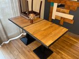 a wooden table with a vase of flowers on top of it