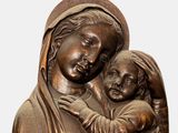 bronze statue of a woman holding a child in her arms