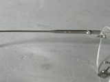 a pair of glasses sitting on a table next to a pair of scissors