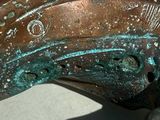 a close up of a bronze statue of a horse ' s head
