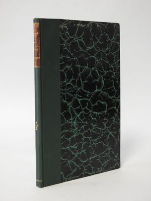 an old book with a green cover and a black cover