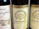three bottles of wine sitting on a table next to each other