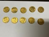 a close up of a bunch of gold coins on a table