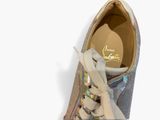 the shoe is silver and has a gold lace on the side