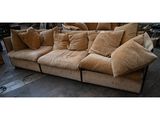 a couch that has many pillows on it