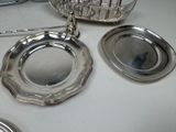 a silver plate on the table next to a basket