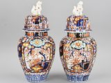 pair of chinese blue and orange vases with birds on top