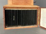 an old wooden box with a bunch of books inside of it