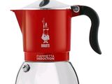 a red and white stove top coffee maker with a black handle