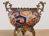 a vase that is sitting on a stand on a table