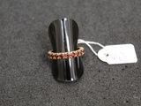 a close up of a ring on a table with a price tag