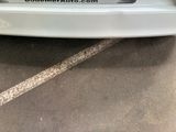 a picture of a white car parked in a parking lot