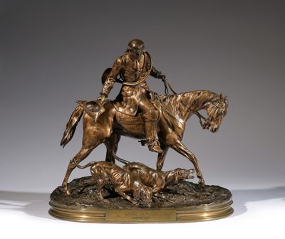 bronze statue of a man on a horse with a dog