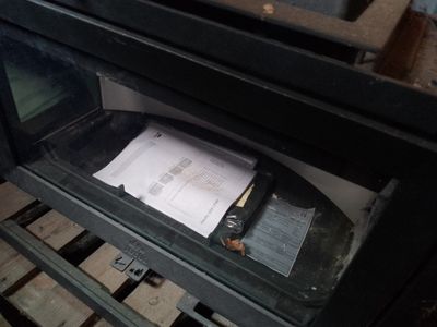 a black oven with a paper on top of it