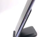 a cell phone sitting on a stand on a white surface