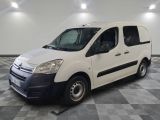the white van is parked on a checkered floor in the garage