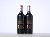 two bottles of wine sitting on top of a table