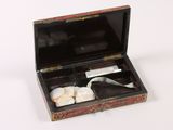 a small box with a pair of scissors in it