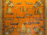 an orange silk scarf with boats and ships on it