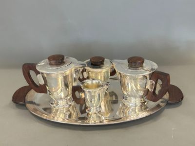 a silver tray with four silver cups and saucers on it
