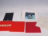 four cards and a picture of a man in a suit and tie on a table