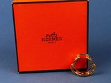 an orange box with a gold ring on top of it