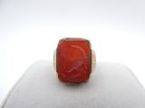 an image of a ring with a red stone in it