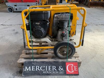 a yellow machine that is sitting on a pallet