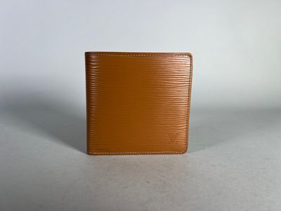 an image of a brown wallet sitting on top of a table