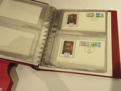 a red binder with stamps inside of it on a table