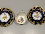 two small plates and a small bowl are sitting on a table