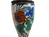 a vase with a flower design on it on a white surface