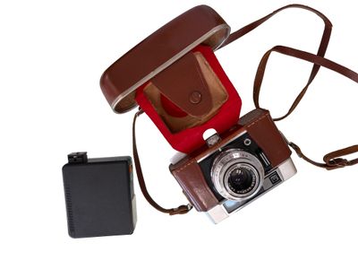 a brown camera and a brown case on a white background