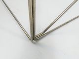 a close up of a metal object on a white surface