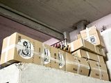 many boxes stacked on top of each other on a shelf