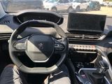 the interior of a car with a steering wheel and a laptop on the dashboard