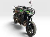a black and green motorcycle parked on a white surface