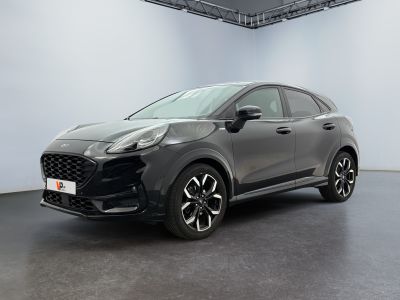 a grey car is parked in a large room with a black floor