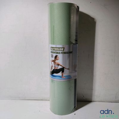 a roll of green yoga mat on a white surface