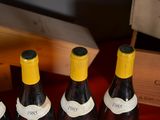 four bottles of wine are lined up on a table