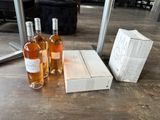 three bottles of wine sitting on a table next to a box
