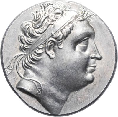 a close up of a silver coin with a man ' s head on it