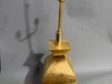 pair of brass candlesticks with a brass base and a brass candle holder