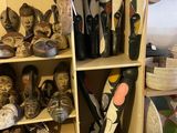 many pairs of skis and ski poles on a shelf